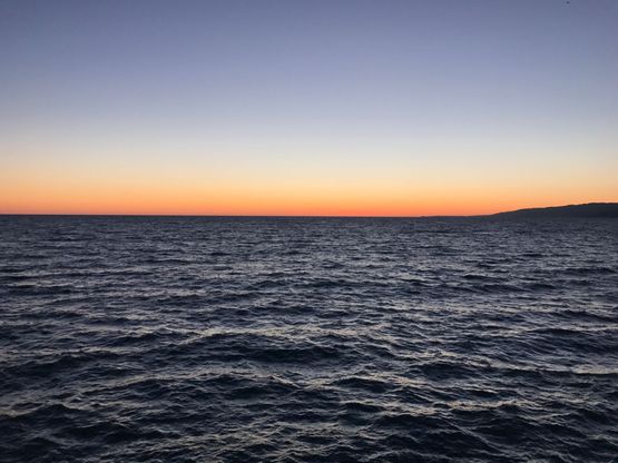 Sunset over open water.
